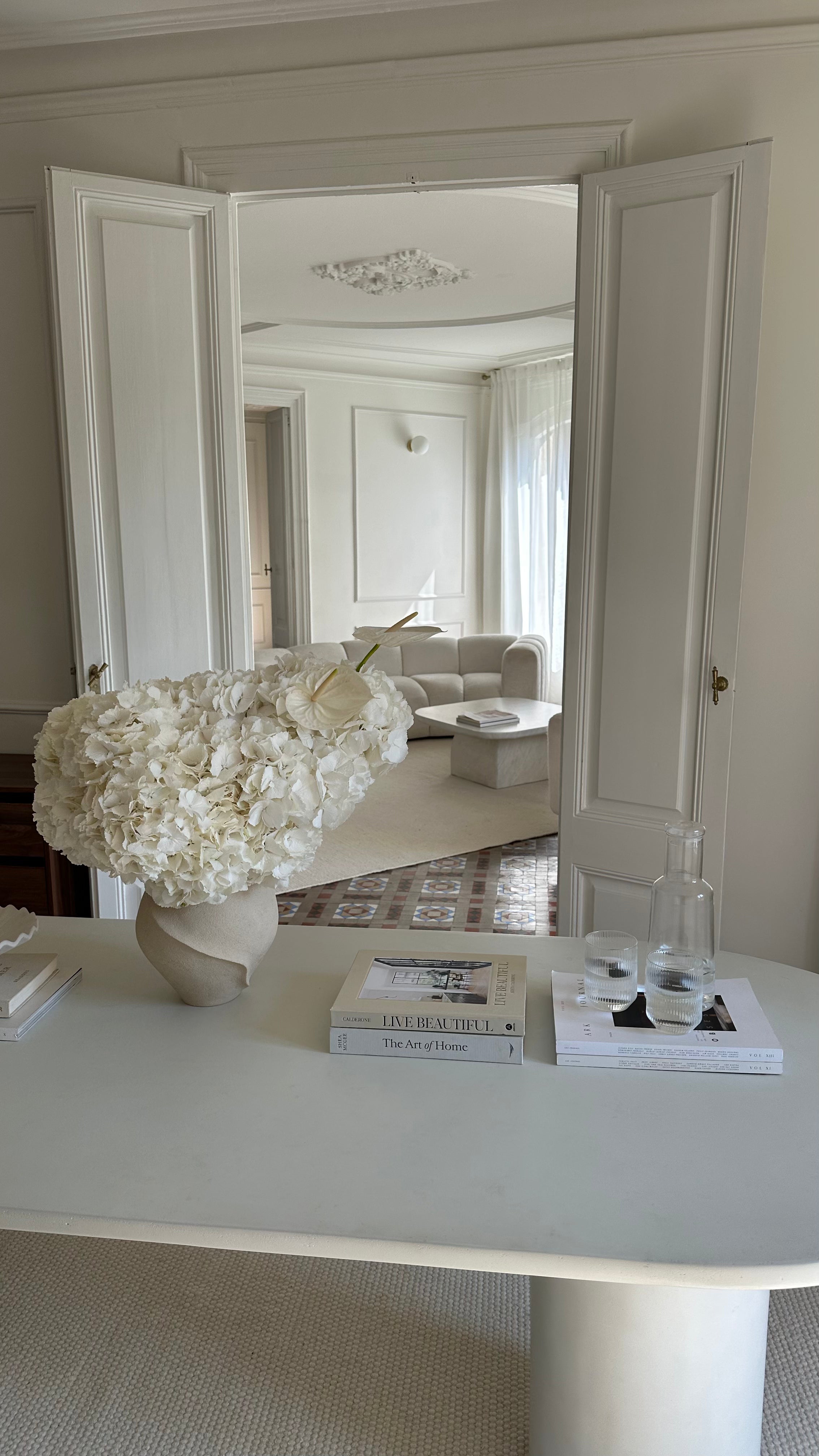 Decorative vase with flowers on a table in a stylish room.