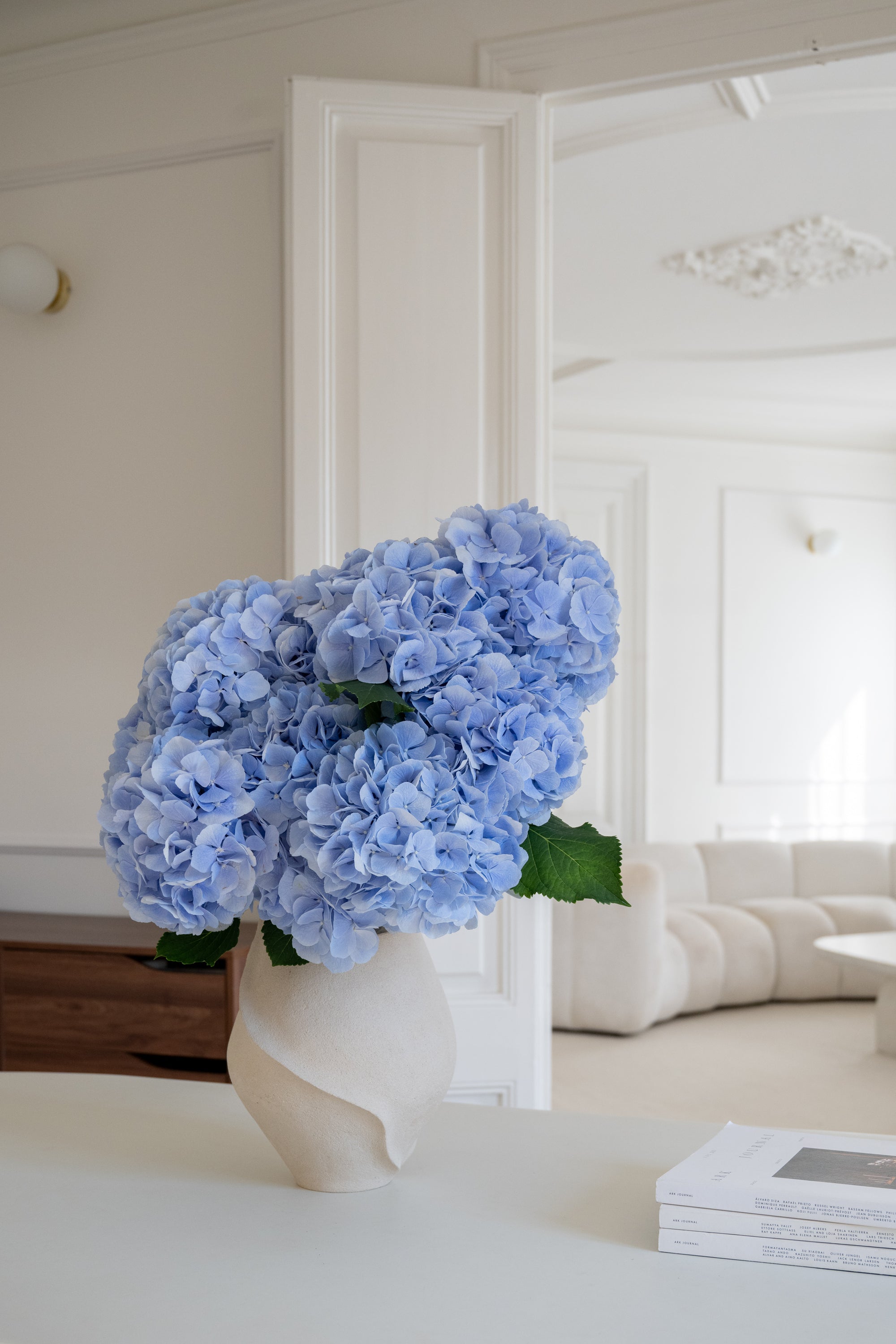 Bouquet of blue hydrangea in a vase on a neutral background