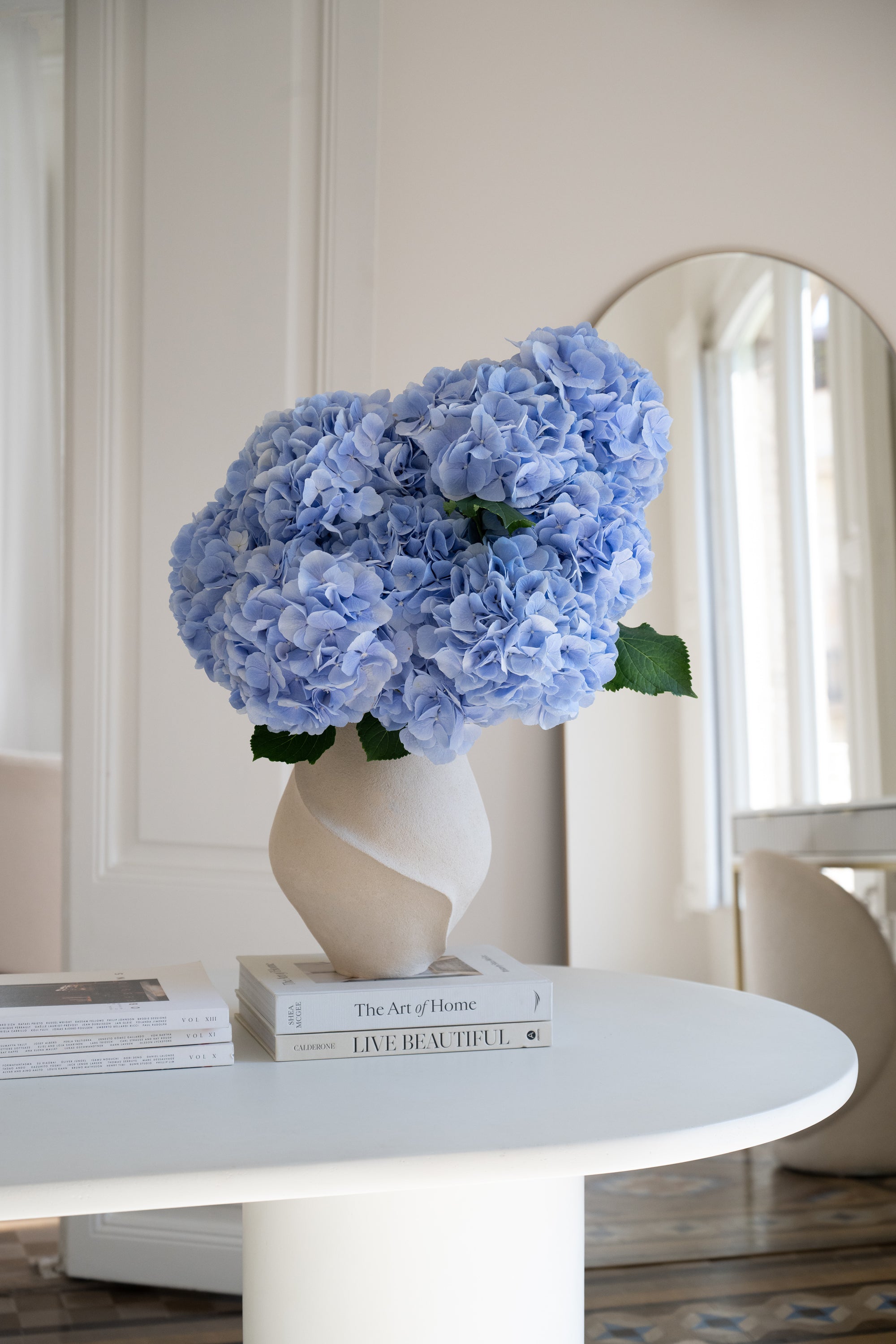 Bouquet of blue hydrangea in a vase on a neutral background