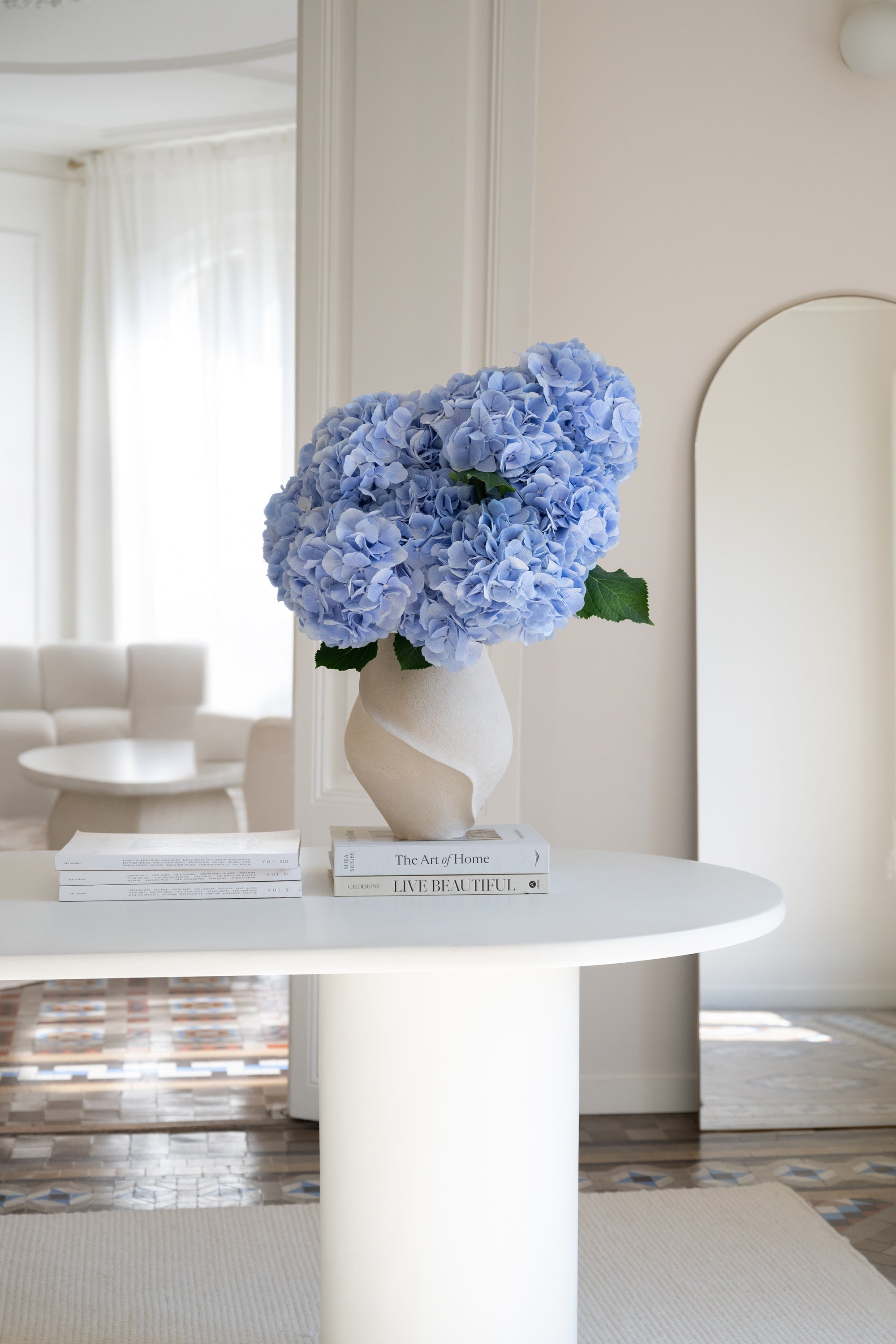 Bouquet of blue hydrangea in a vase on a neutral background