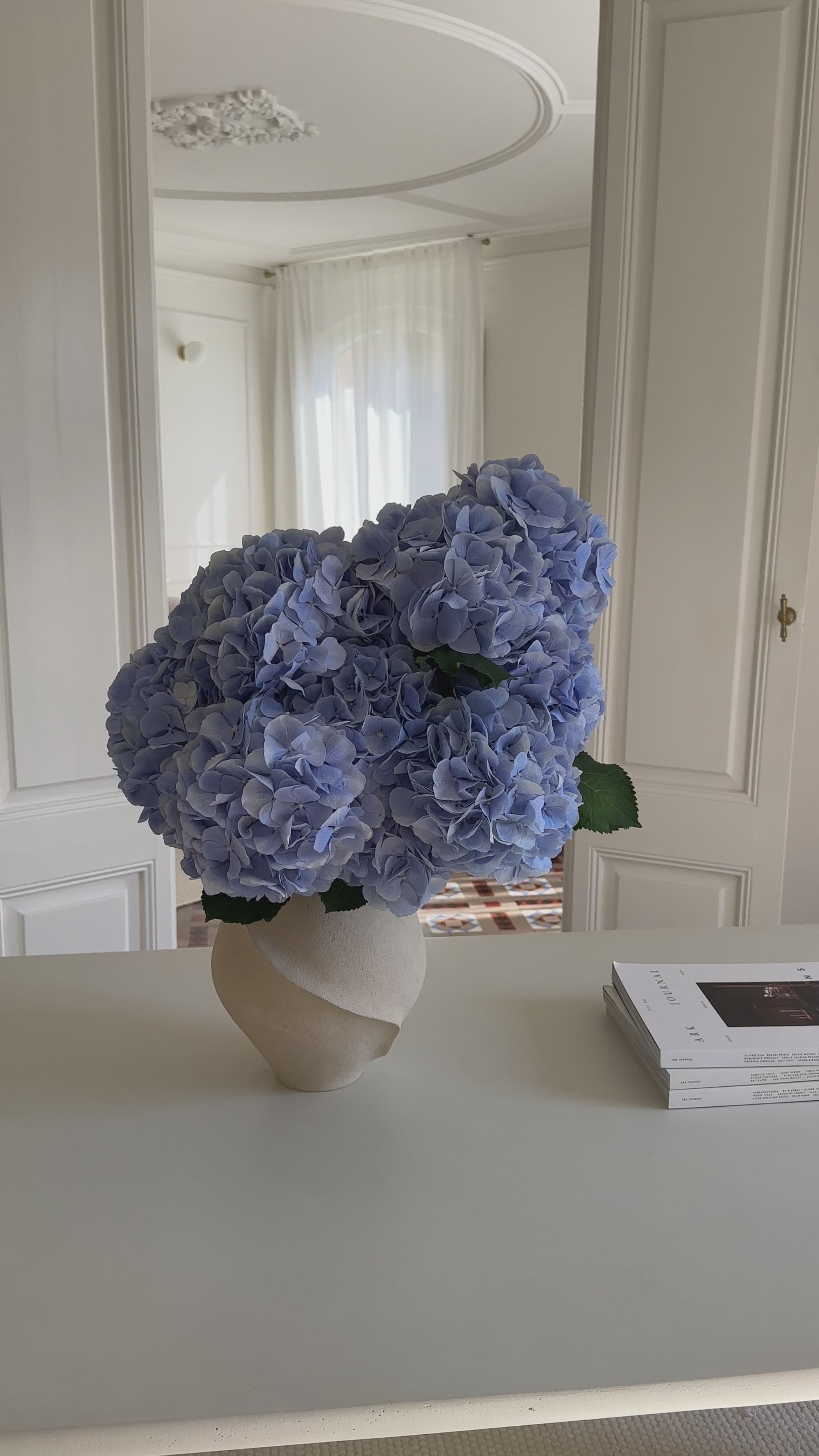 Bouquet of blue hydrangea in a vase on a neutral background